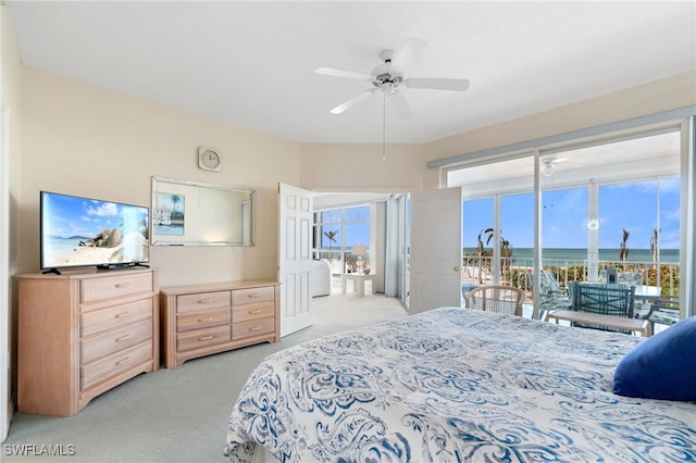 bedroom featuring ceiling fan, light colored carpet, access to outside, and multiple windows