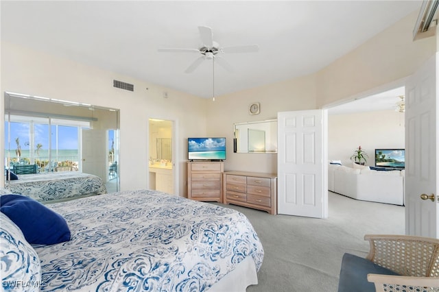 bedroom featuring ceiling fan, light colored carpet, and connected bathroom