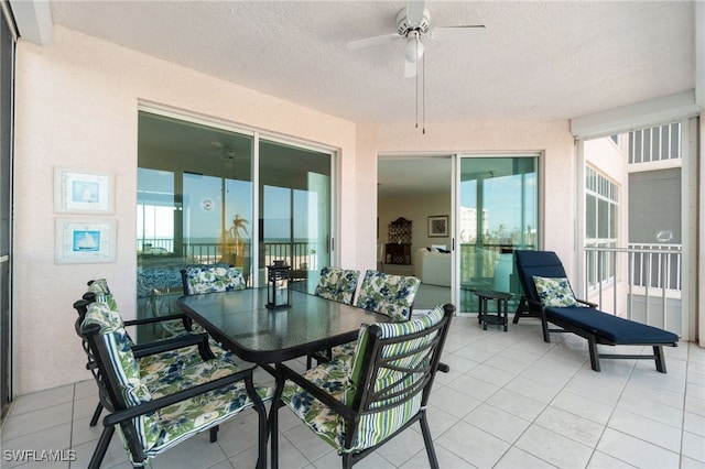 exterior space featuring ceiling fan and a textured ceiling