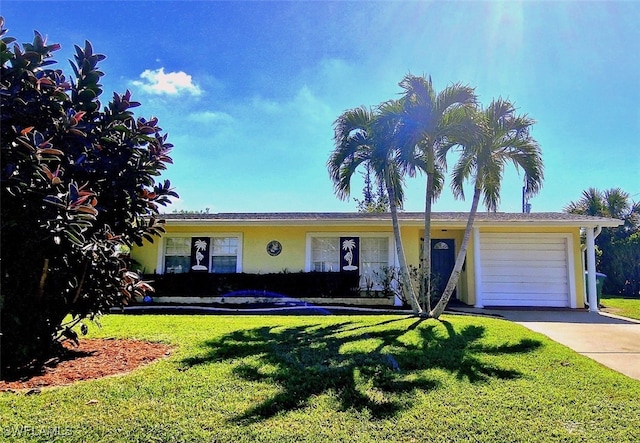 view of front of house with a garage and a front lawn