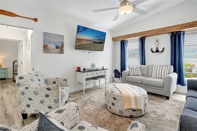 living room featuring ceiling fan, light hardwood / wood-style flooring, and vaulted ceiling