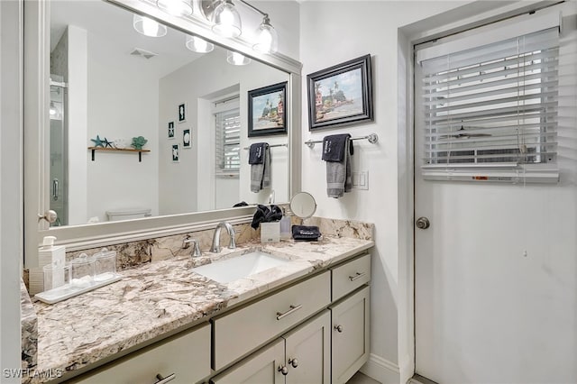 bathroom featuring vanity and toilet