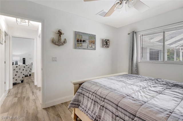 bedroom with ceiling fan and light hardwood / wood-style flooring