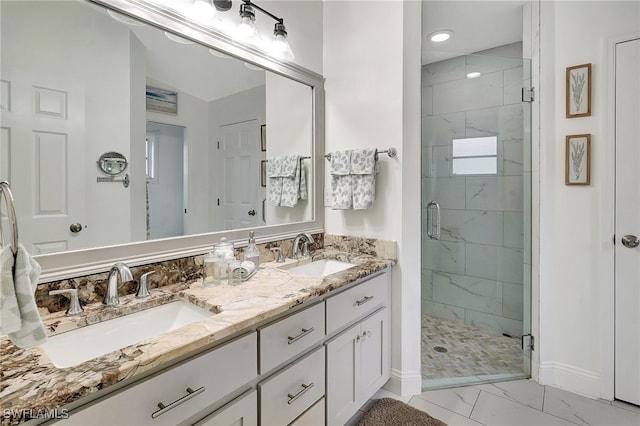 bathroom featuring vanity and a shower with door