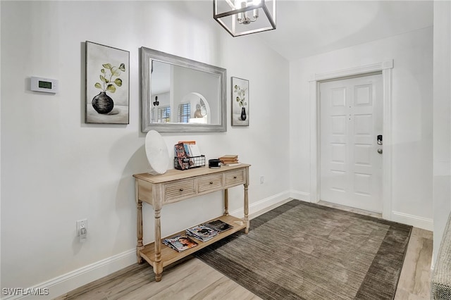 foyer featuring dark hardwood / wood-style flooring and an inviting chandelier