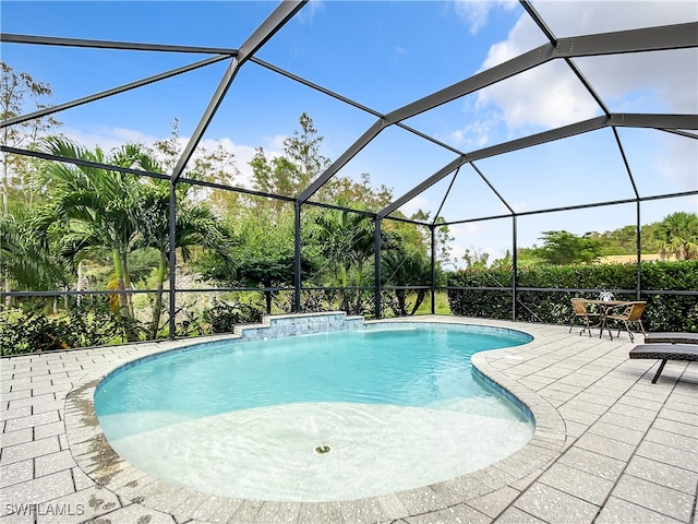 view of pool featuring a lanai, a patio area, and pool water feature