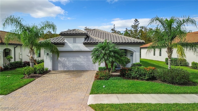 mediterranean / spanish-style home featuring a front yard and a garage