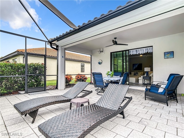 view of patio with glass enclosure and ceiling fan