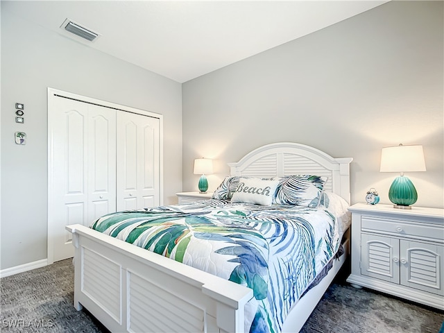 bedroom featuring dark carpet and a closet