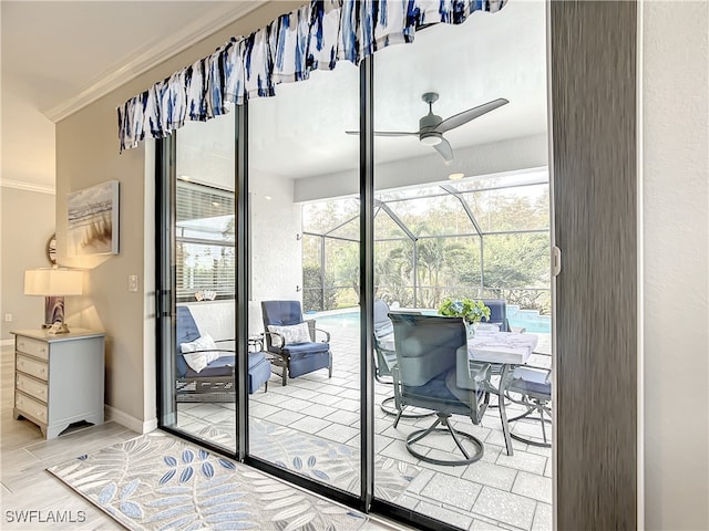 doorway to outside with hardwood / wood-style flooring, ceiling fan, and ornamental molding