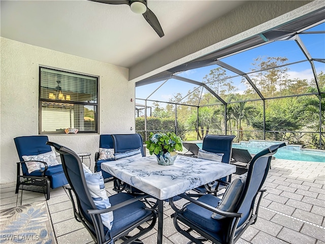 view of patio / terrace with ceiling fan and a lanai