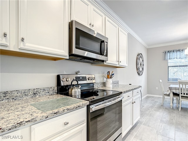 kitchen featuring light stone counters, white cabinetry, crown molding, and appliances with stainless steel finishes