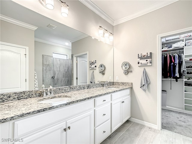 bathroom featuring tile patterned flooring, vanity, crown molding, and walk in shower