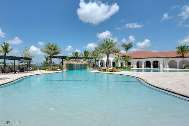 view of swimming pool featuring a pergola and a patio