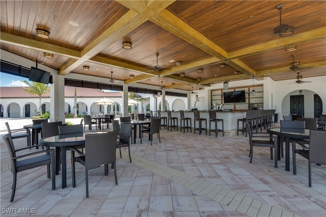 view of patio with ceiling fan and exterior bar