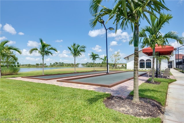 exterior space featuring a water view and a yard