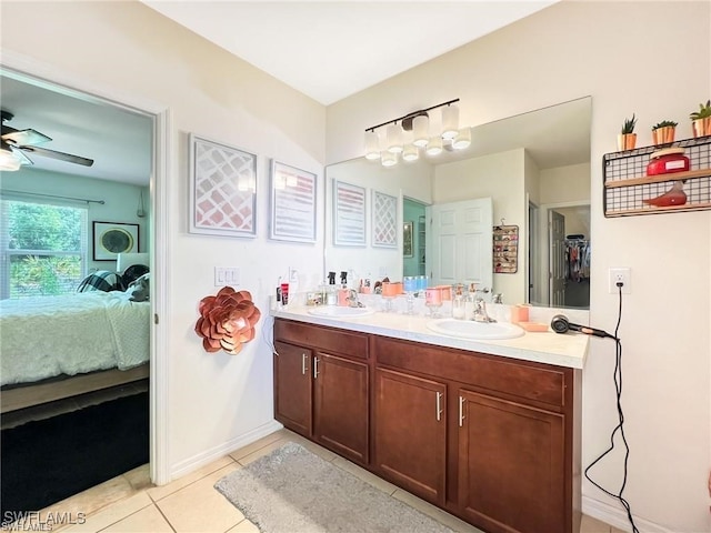 bathroom with tile patterned flooring, vanity, and ceiling fan