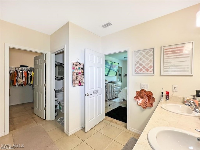 bathroom with tile patterned floors, vanity, and toilet