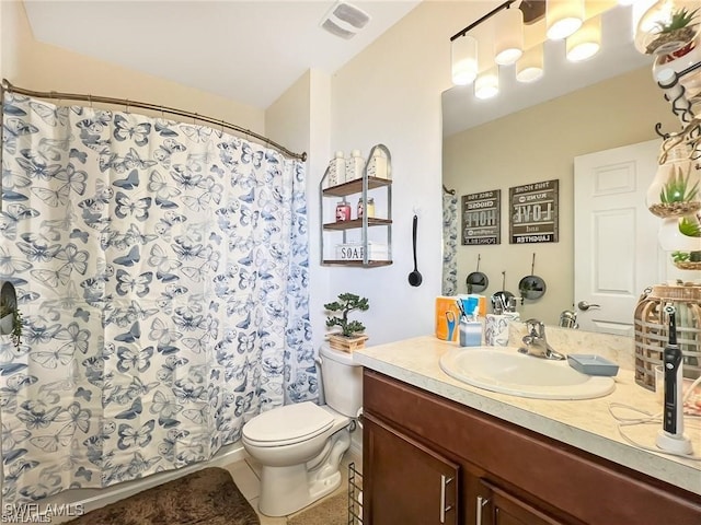 bathroom with tile patterned floors, vanity, and toilet