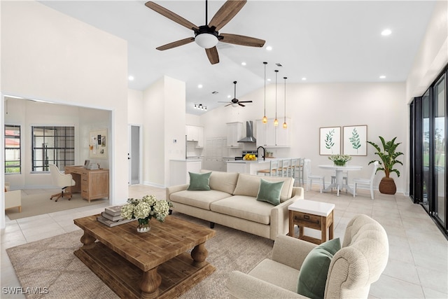 living room with light tile patterned floors, high vaulted ceiling, ceiling fan, and sink