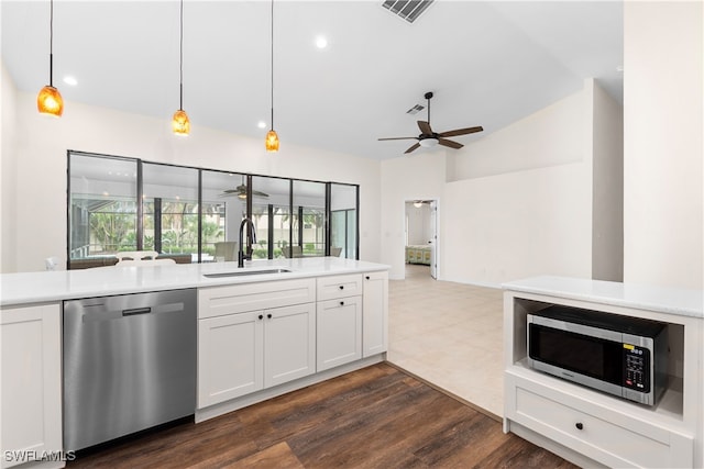 kitchen featuring sink, hanging light fixtures, stainless steel appliances, dark hardwood / wood-style flooring, and white cabinets