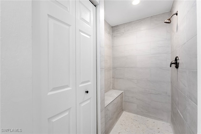 bathroom with a tile shower