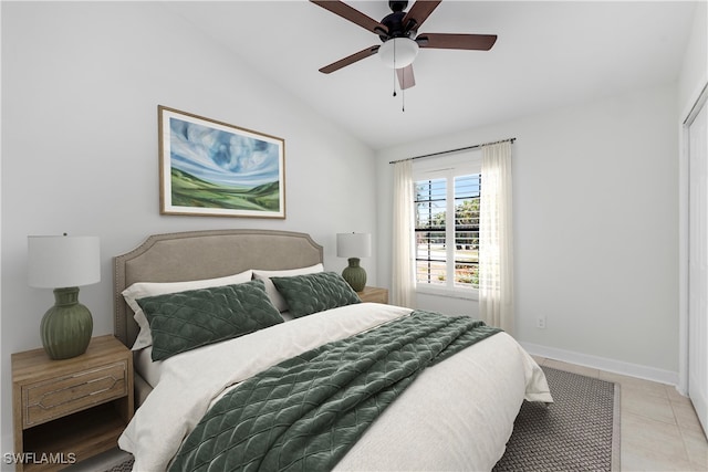 bedroom featuring light tile patterned floors, ceiling fan, and lofted ceiling