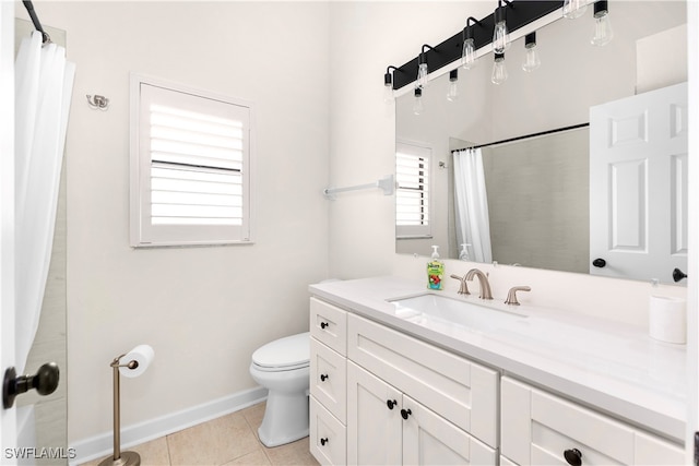 bathroom featuring tile patterned flooring, vanity, and toilet