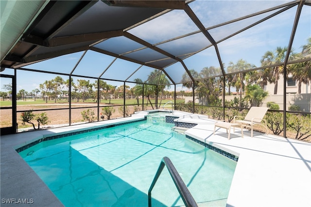 view of pool with a lanai, a patio area, and an in ground hot tub