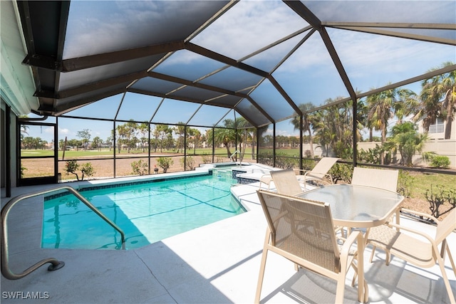 view of swimming pool featuring a patio area and a lanai