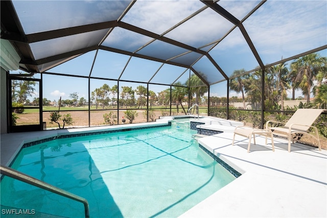 view of pool featuring glass enclosure and a patio area