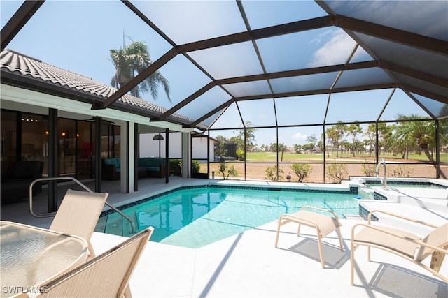 view of swimming pool with an in ground hot tub, a patio, and a lanai