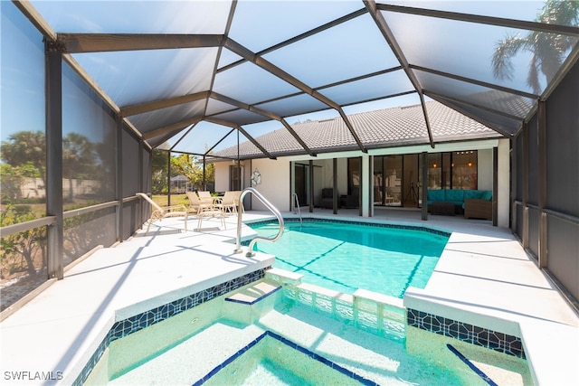 view of swimming pool with a patio, glass enclosure, and ceiling fan