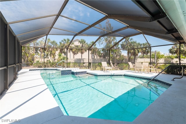 view of pool featuring glass enclosure and a patio