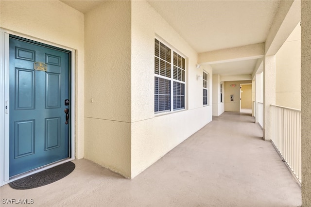 entrance to property featuring stucco siding