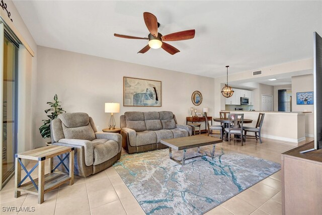 living room with light tile patterned floors and ceiling fan