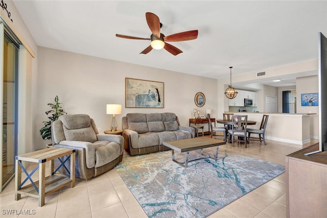 living room featuring ceiling fan, visible vents, and light tile patterned flooring