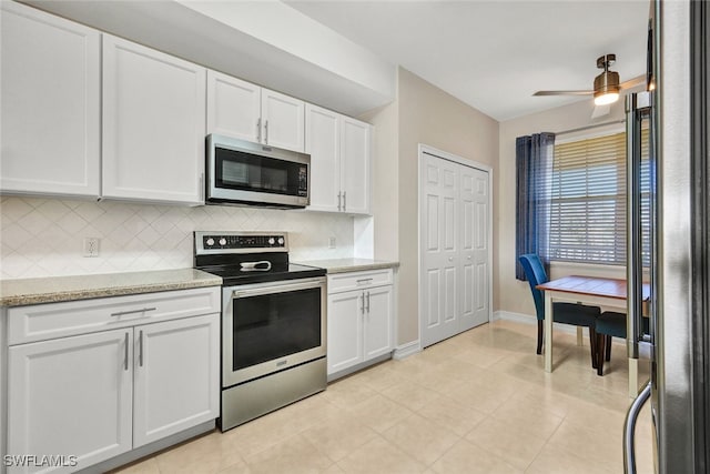 kitchen with white cabinetry, ceiling fan, light stone counters, backsplash, and appliances with stainless steel finishes