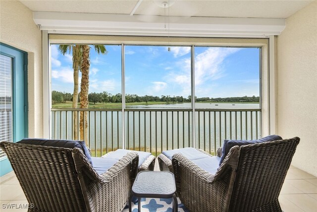 sunroom / solarium with a water view and a wealth of natural light