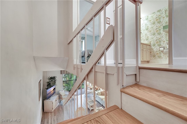 staircase featuring wood-type flooring