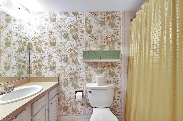 bathroom featuring tile patterned flooring, vanity, and toilet