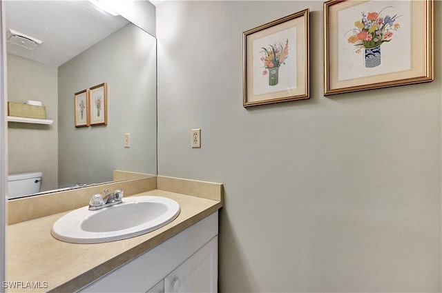 bathroom featuring vanity and toilet