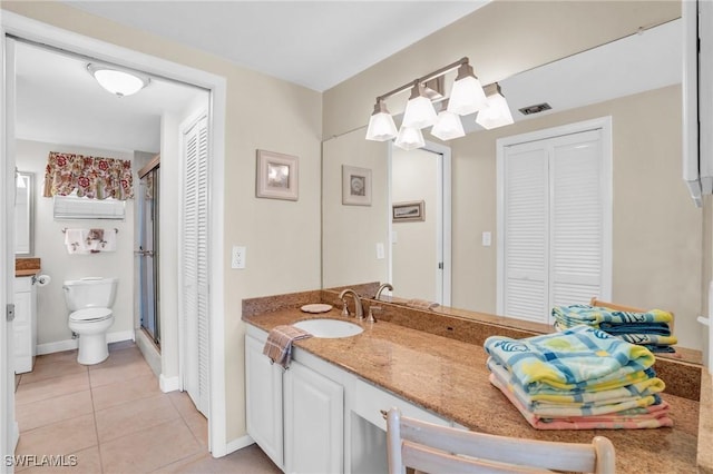 bathroom featuring tile patterned floors, toilet, and vanity