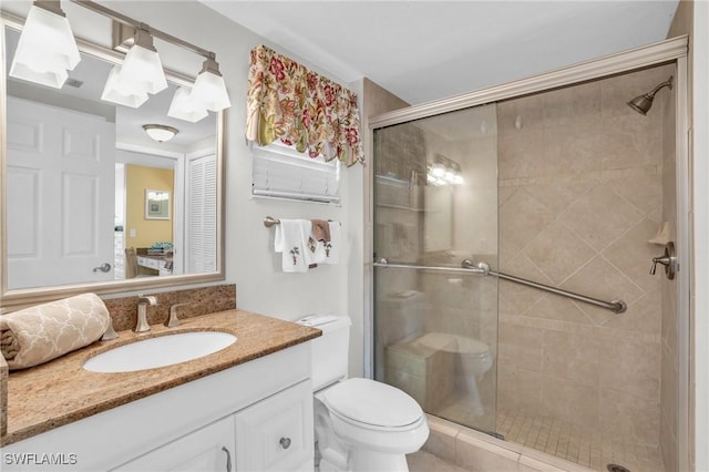 bathroom featuring vanity, toilet, and walk in shower