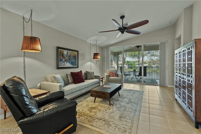 living room with ceiling fan, light tile patterned floors, and vaulted ceiling