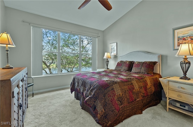 bedroom with ceiling fan, lofted ceiling, and light carpet