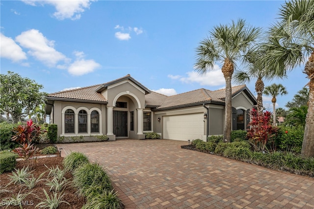 mediterranean / spanish-style home with a garage