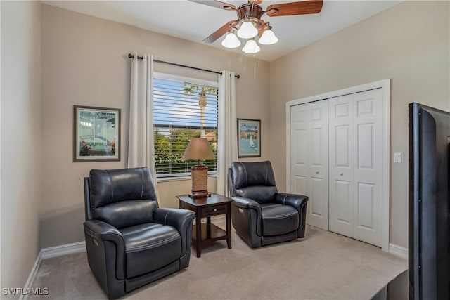 sitting room with light colored carpet and ceiling fan