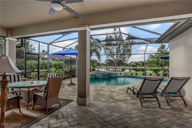 view of swimming pool with a water view, ceiling fan, a lanai, an in ground hot tub, and a patio area