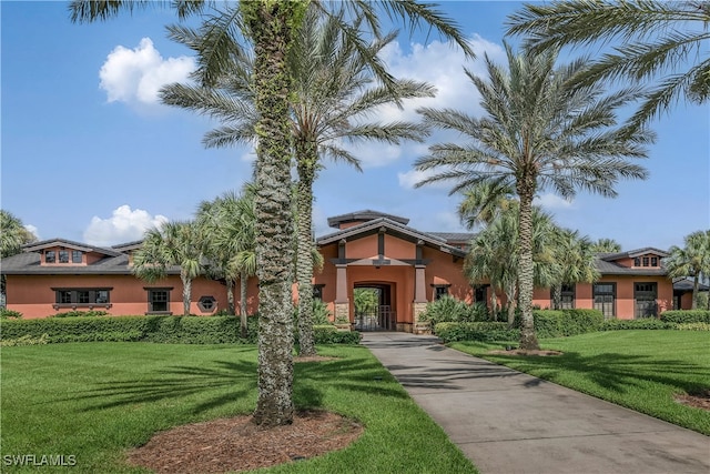 mediterranean / spanish house featuring a front lawn